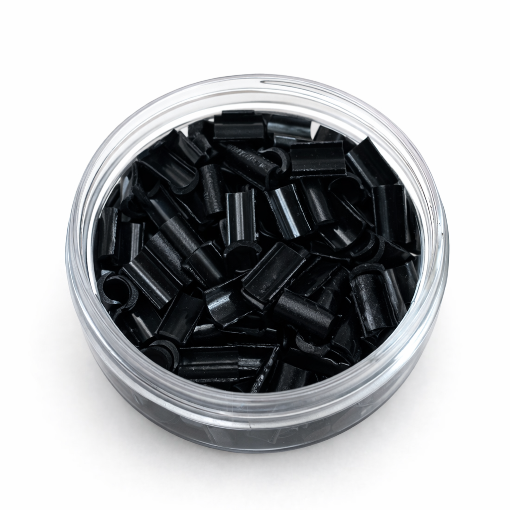 Clear container filled with black cylindrical objects on a white background