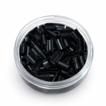 Clear container filled with black cylindrical objects on a white background
